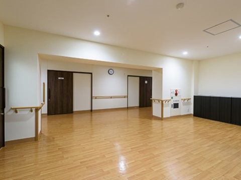 廊下からドアなどで仕切られることなく続く、広い空間。天井のダウンライトがうつるくらい磨かれたフローリング床が気持ちいい。