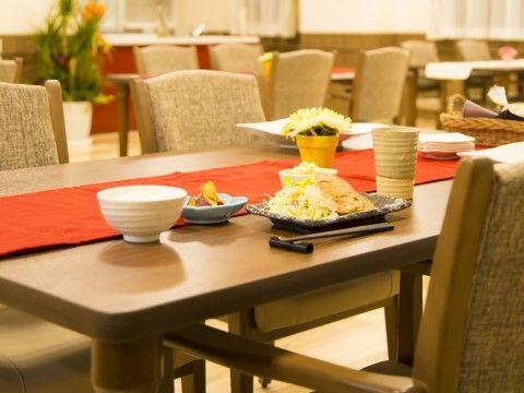 食堂のテーブルの上にお食事がセットされている。テーブルマットも置かれたレストランのような雰囲気の中でお食事ができる。