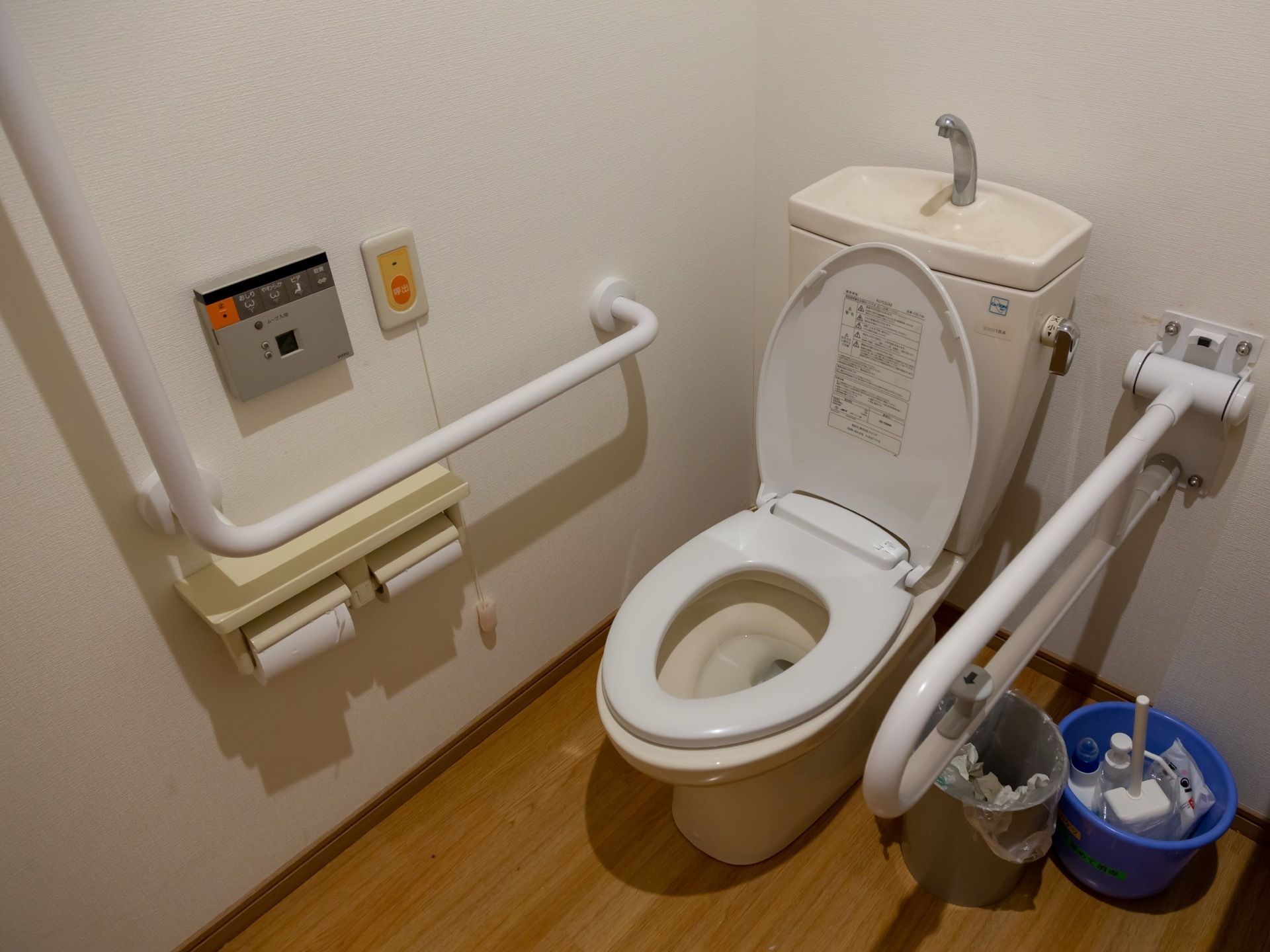 トイレには温水洗浄便座を用意している。壁のパネルで操作するタイプになっており、パネルの横に非常ボタンが設置されている。