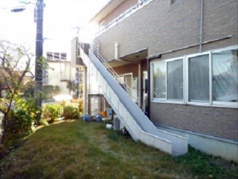 2階のベランダから1階へと緩い傾斜で伸びる、緊急用の滑り台