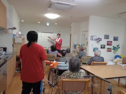 レクリエーションに参加し、スタッフの説明に耳を傾ける入居者様