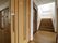 スライド式の出入り口の側にはエレベーターホールと階段がある。天井の高い明るい踊り場があり、壁には絵が掛けられている。
