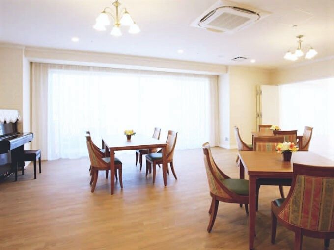 壁の一面が大きな窓になっていて陽が良く差し込む。広いスペースにテーブルやソファーが余裕を持って配置されている。