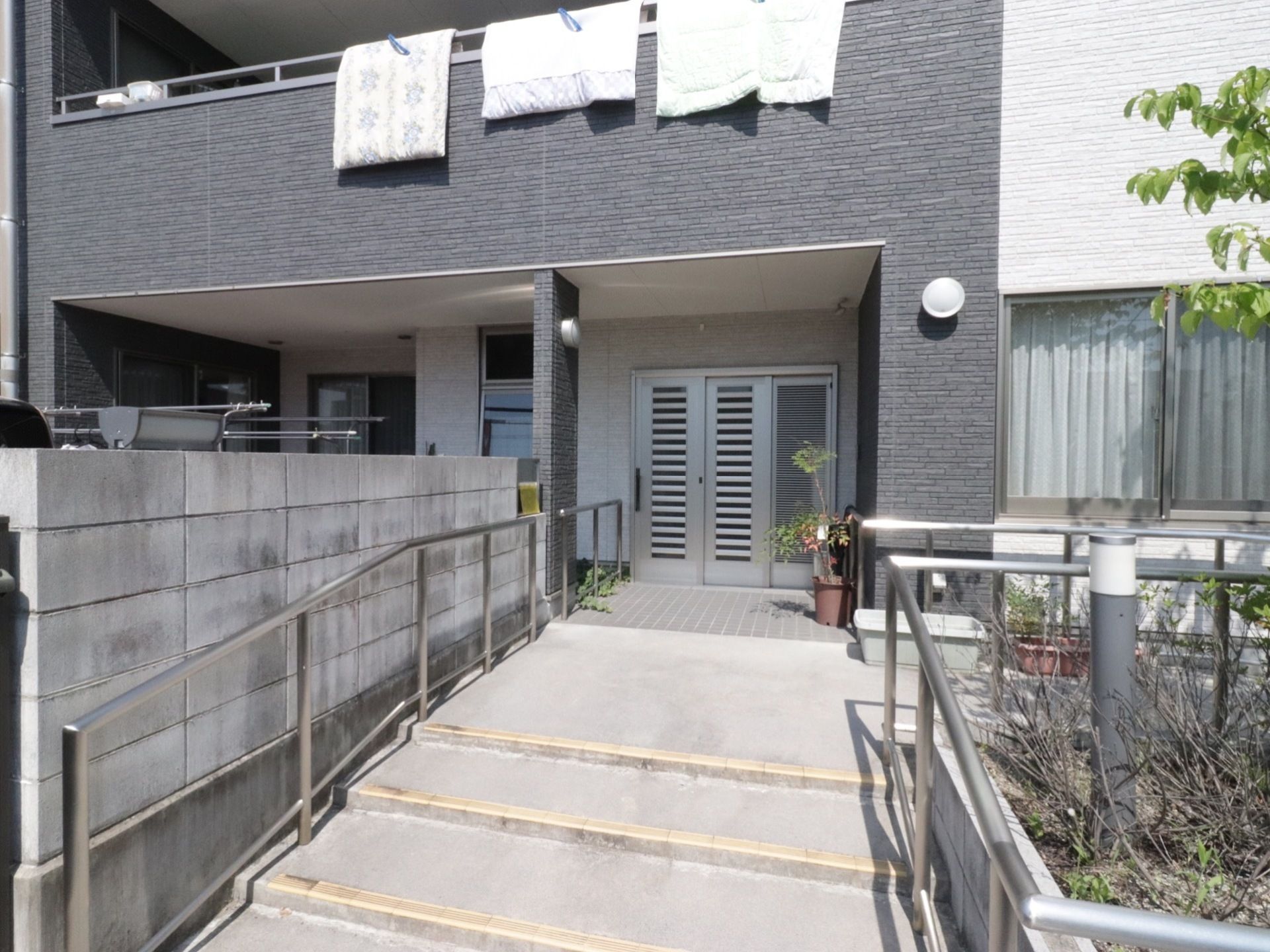 玄関前に設置された、緩やかな階段と体を支えることができる手すり