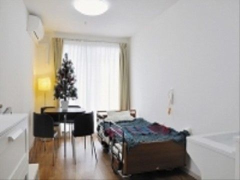 部屋の奥には大きな窓がある。エアコンは全室に完備されている。ベッドにテーブルと椅子、タンス等の家具がある。
