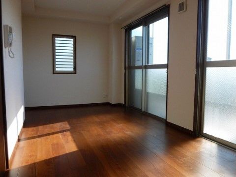 ベランダのあり、外からの陽射しが入る明るい居室である。床はフローリングで、壁に連絡用の電話が設置されている。