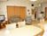 リビングの壁に入居者の手作りの品や写真が飾られている。ソファとテレビがあるのでリラックスして過ごせる。