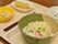 おぼんに乗せられたうどんの器。かまぼこや葱が上に盛り付けられ色彩を添えている。ほかにも3つのお皿がのっている。