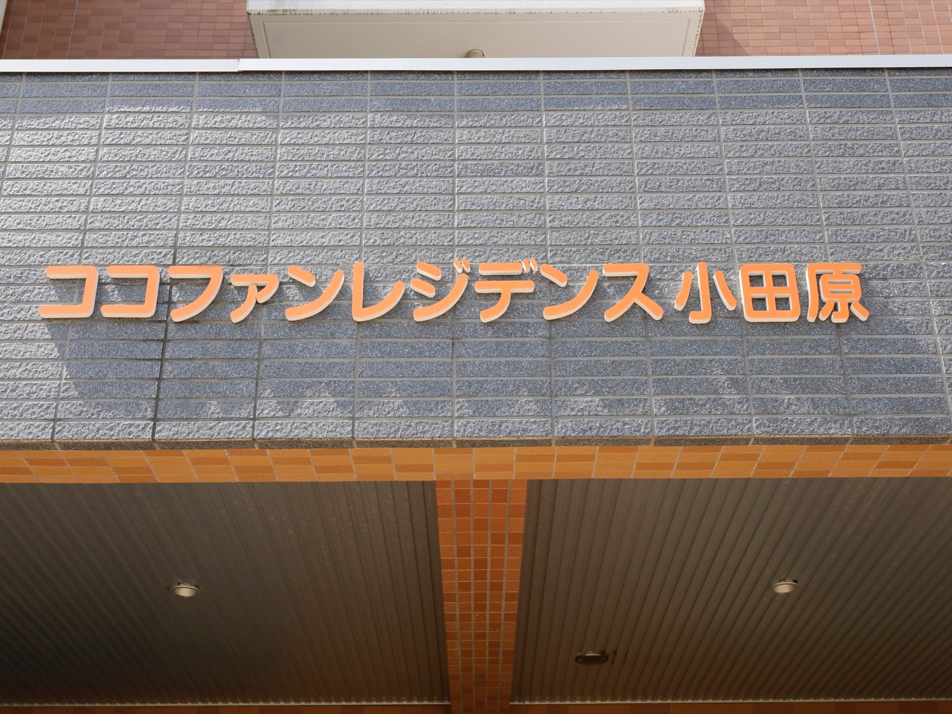 玄関前の外壁に施設名が描かれている。最寄り駅から近く、施設から富士山が見える立地で、設備も充実している。
