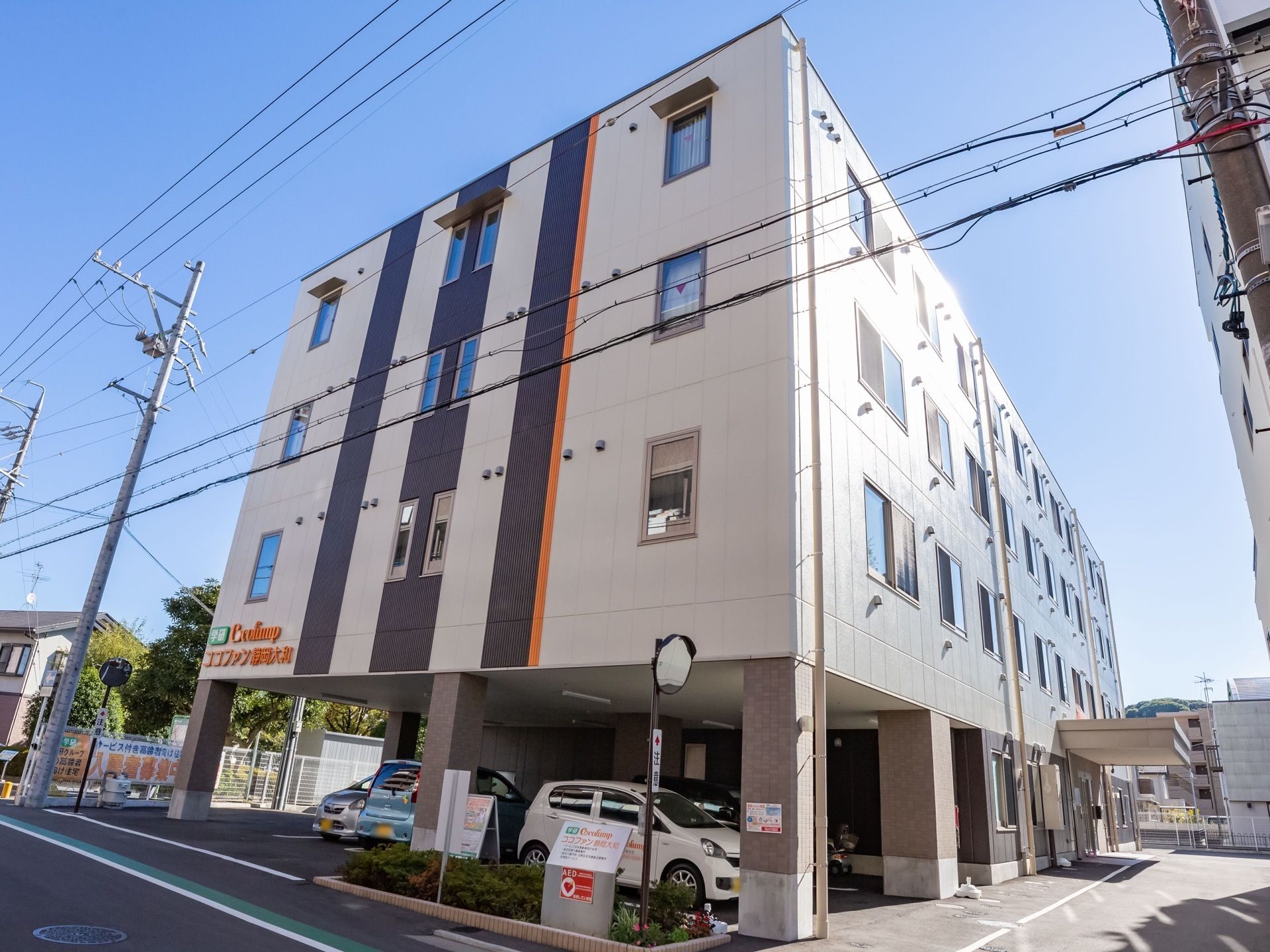 ４階建てで、肌色、茶色、オレンジ色でデザインされた建物である。１階部分は駐車スペースとしても利用されている。