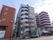 ８階建てのマンションのような建物の介護施設である。綺麗なグレーカラーの建物で、入居者様をお出迎えさせていただく。
