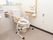 便座の両脇に手すりが固定されたトイレである。壁には洗浄等を行うボタンのほか、スタッフを呼び出すナースコールが取りつけられている。