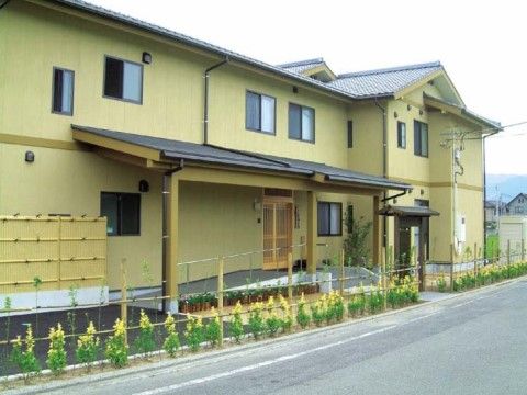 緩やかなスロープと大きな庇のついた和風旅館のような外観