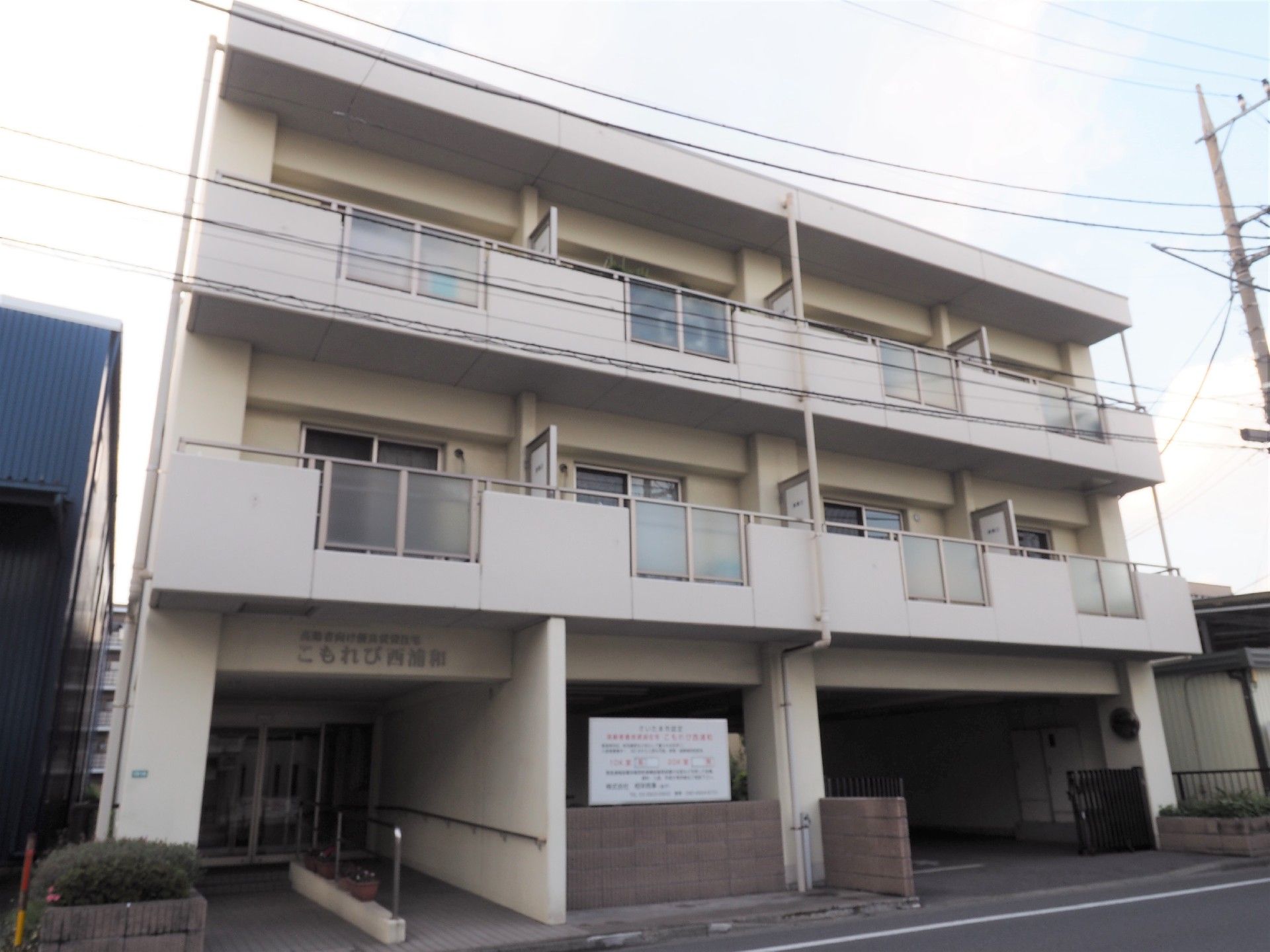 道路に面した場所に建設されている、三階建ての施設外観