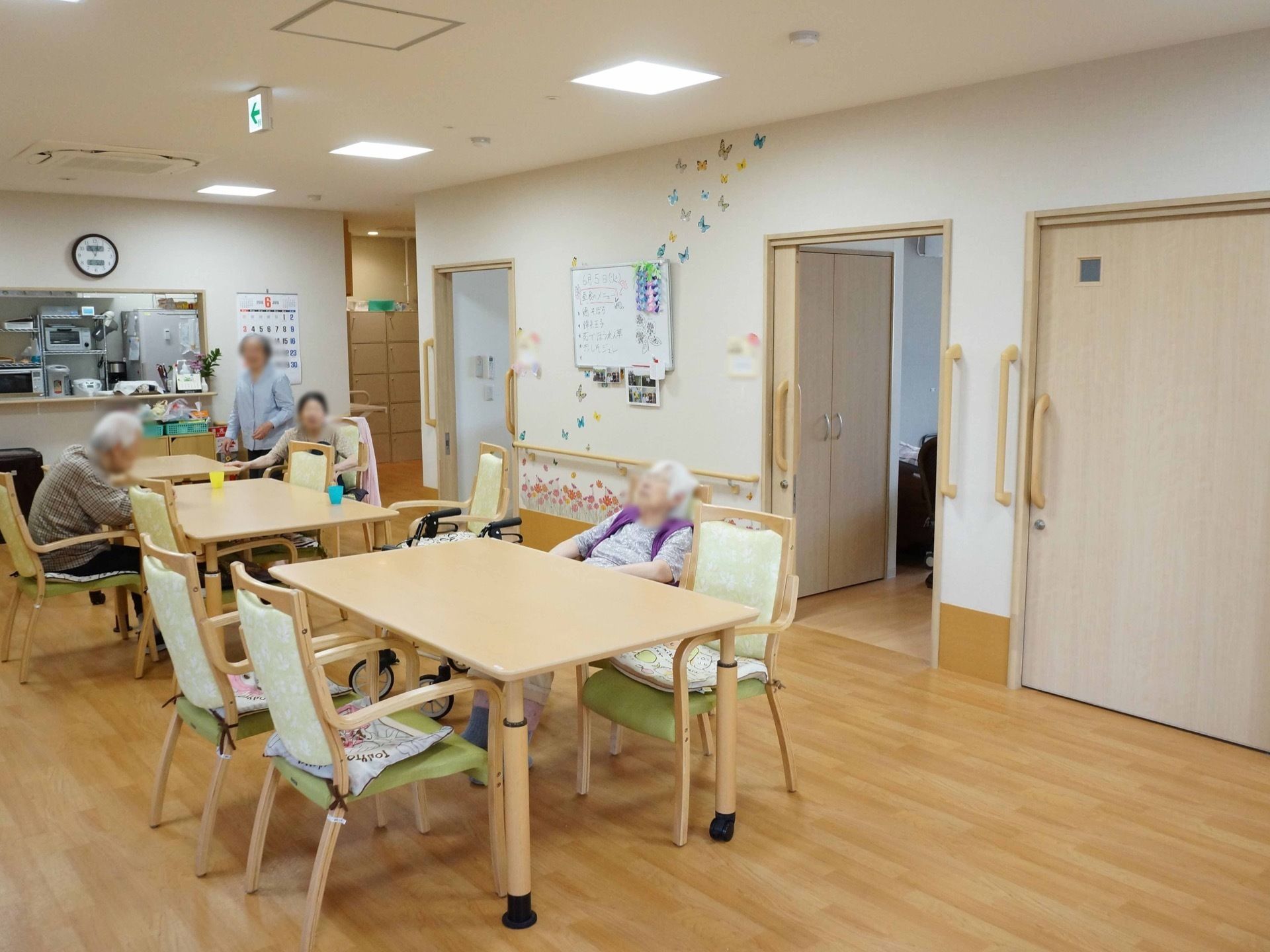 居室前に設けられたリビングに隣接してキッチンスペースがある。冷蔵庫や電子レンジ、ポットなどが置かれている。