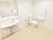 白で統一されたトイレの左奥は便座があり右手と左手の壁際にL字型の手すりと呼び出しベルやトイレットペーパーがついている。