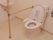 トイレには快適に使用していただけるよう、便座の周りに大きな手摺りが設置されている。奥に手洗いも設置されている。