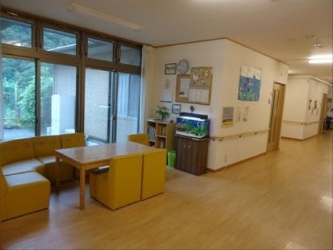 共有スペースの窓からは庭の緑が見え、日当たりもよく過ごしやすい。入居者様が気軽に利用でき、憩いの場となっている。