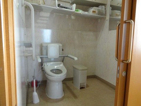 スペースが広く、ドアは引き戸になっている。床面は段差がない。洋式便器が設置されており、便器脇と壁面には手すりが付いている。