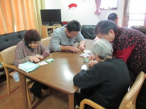 入居者様が集まって、折り紙教えたり教わったりしている様子