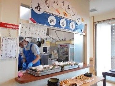厨房のカウンターにてお寿司バイキングを行う様子。目のまえで出来立てのお寿司を握っている