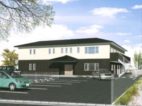 上下2色に塗り分けられた、和風の住宅のような2階建ての施設建物