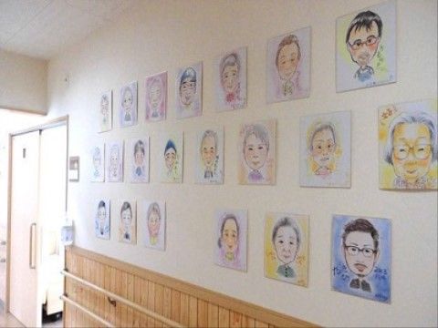 入居者様やスタッフの似顔絵が掛けられている、廊下壁の一部