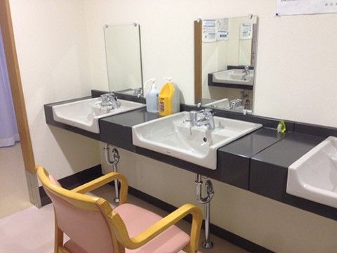 黒い台の上に四角く、前面が凹んだ洗面ボウルが３つ並んでいる。それぞれにシングルレバー水栓が付いている。