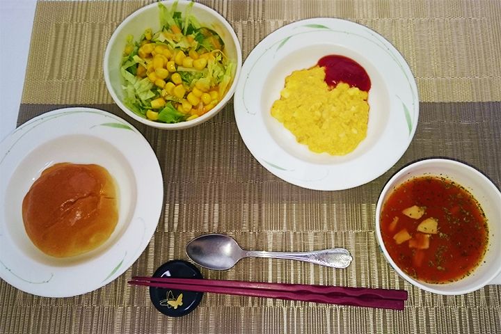 バターロールとコーンサラダとスクランブルエッグとスープのセット