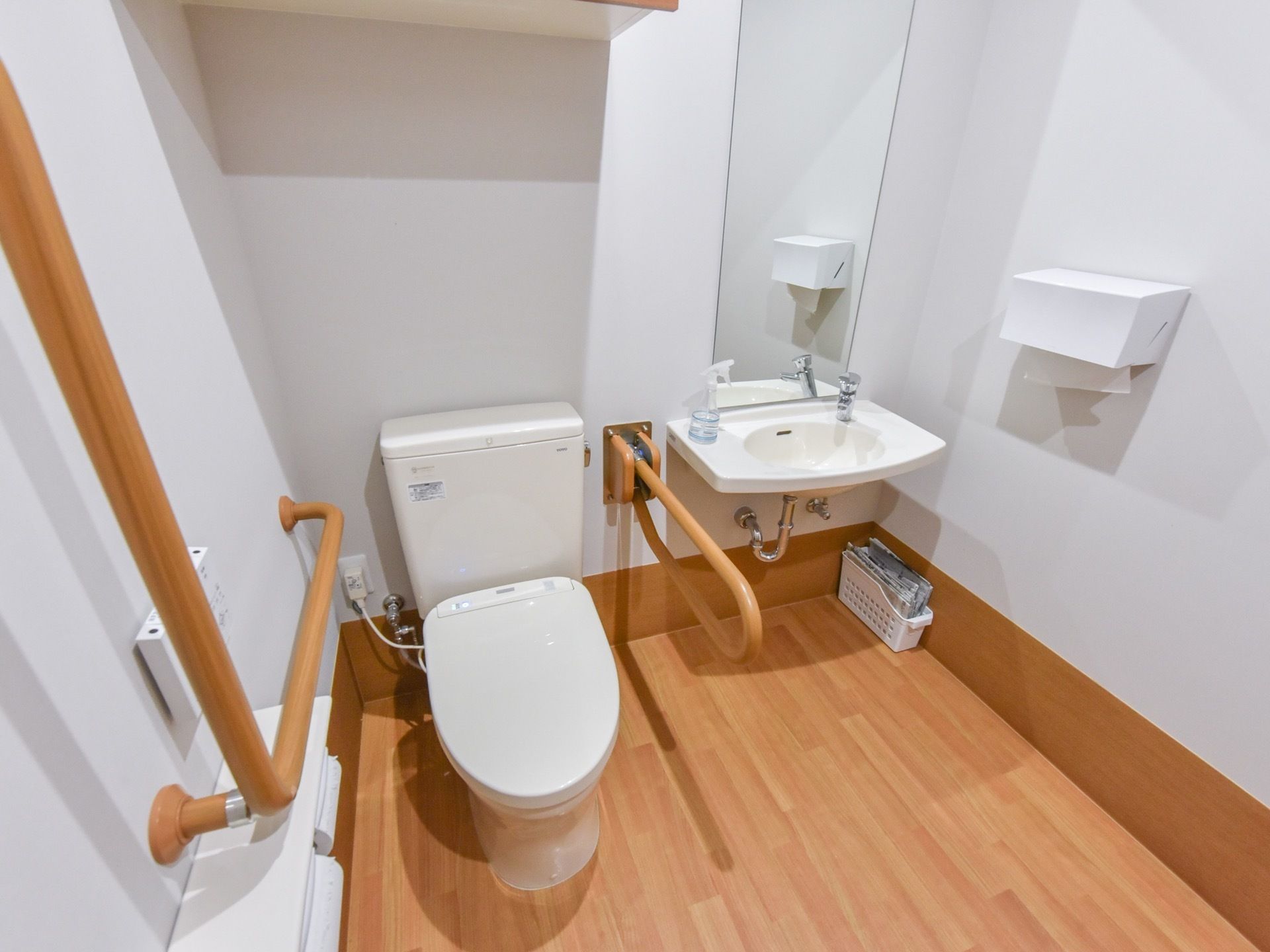 向って左側に便座付き便器が、右側には洗面台がそれぞれ設置されている。洗面台の鏡は縦長で顔だけでなく、全身も見やすい。