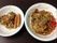 お皿にたこ焼きとソーセージ、焼きそばが盛り付けられている。バラエティ豊かな食事メニューが用意されている。
