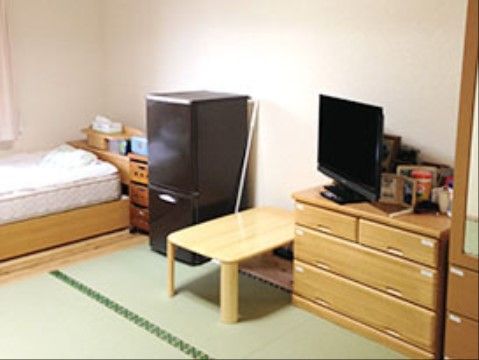 明るい白い壁の部屋は、畳敷きである。分厚いマットの木製のベッドや小型冷蔵庫、テーブル、チェストなどがある。