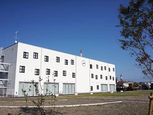 施設の建物は、とても広い敷地の中に建っており、周囲には視線を塞ぐ建造物は何もない。外観は、外壁が白一色の四角いシンプル設計になっている。