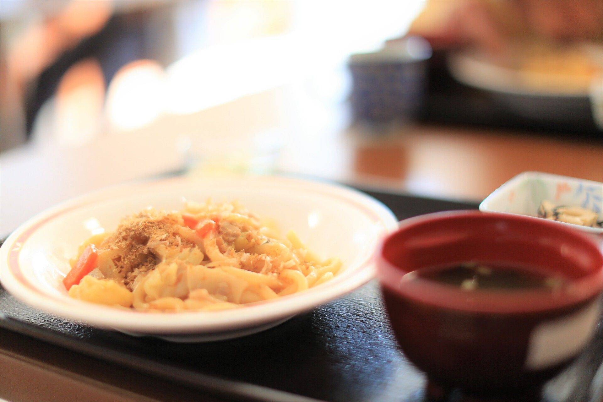 野菜がたくさん入った焼うどんと汁物、小鉢がセットになった食事