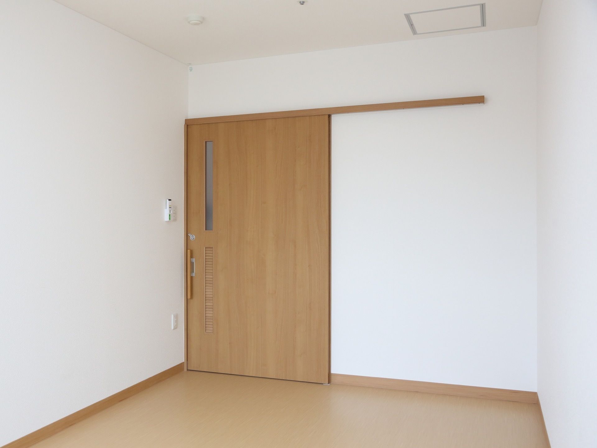 居室の床は、段差のないバリアフリーを採用している。また入口には鍵のついた、スライド式の扉を設置している。