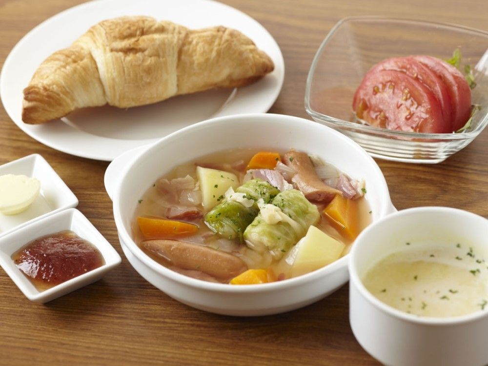 パンとトマトサラダ、ポトフ、コーンスープが並んだバランスのいい食事