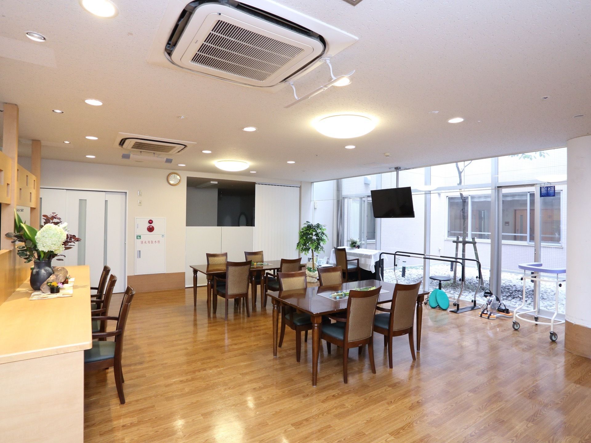 日差しの入る明るい部屋になっている。向かい合って座れる机と椅子を用意している。また、歩行練習のための手すりや、歩行補助器も用意してある。