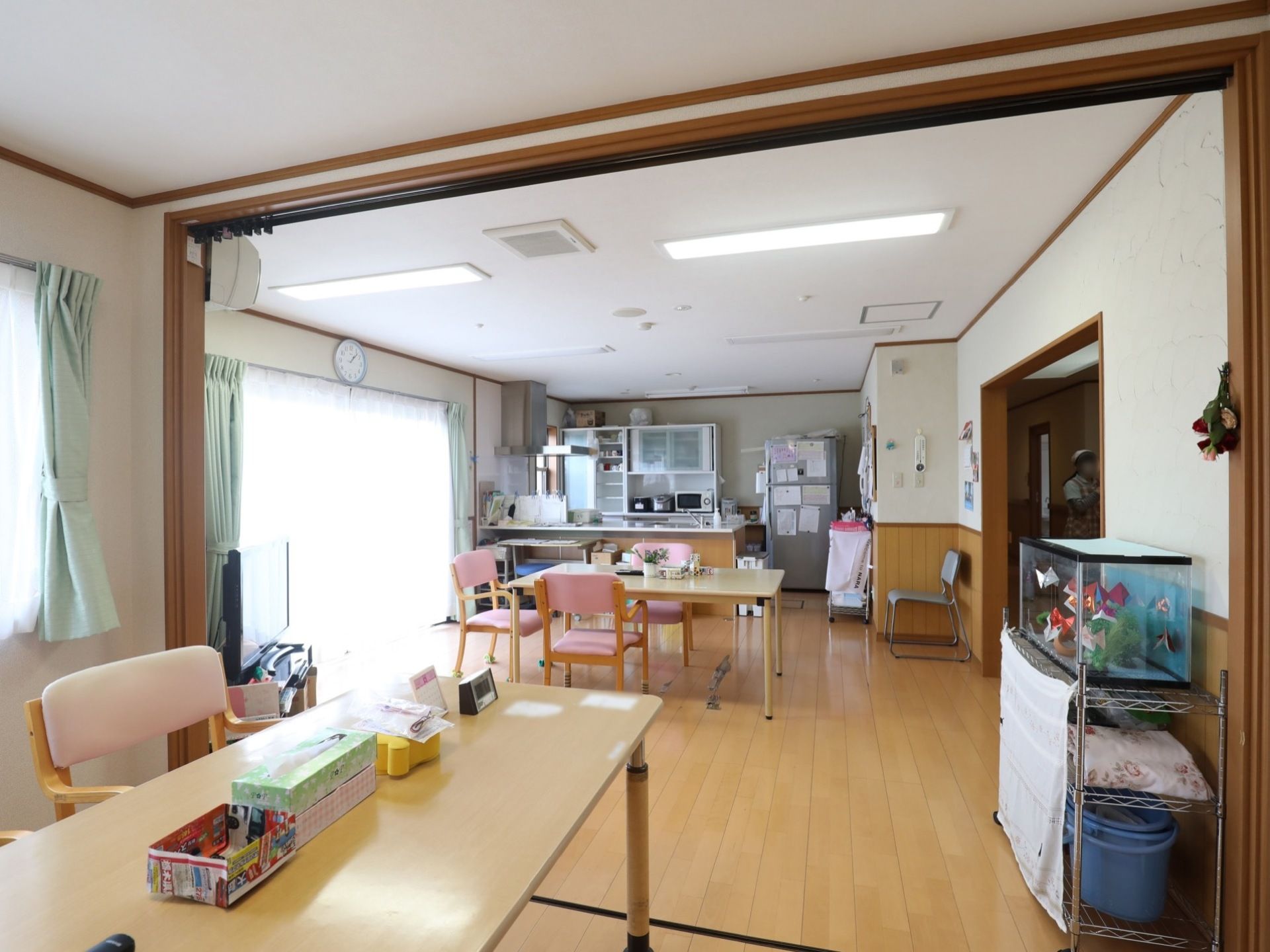食事を楽しんだり、くつろぐことができる広いスペースである。奥にはキッチンがあり、施設で食事の調理をしている。