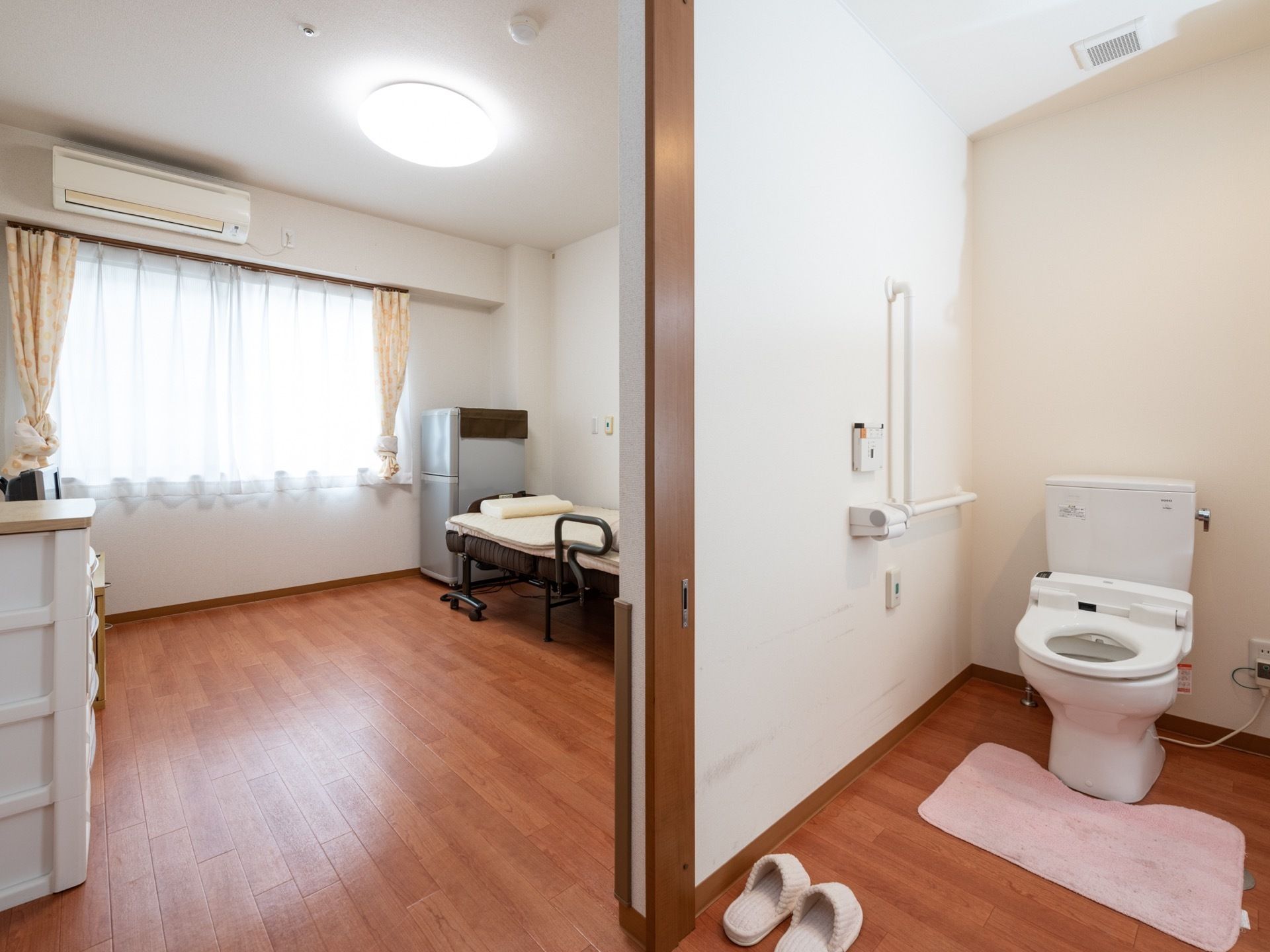 居室には大きな窓から光が差し込み、部屋全体が明るくなっている。広々とした居室で、開放的な空間である。