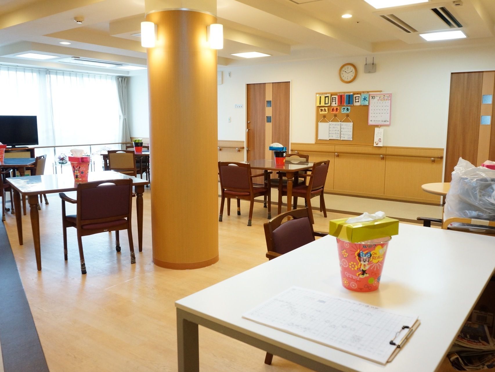 天井には正方形型の照明があり、エアコンが付いている。複数のテーブルがあり、その上には円柱形の入れ物とティシュがある。