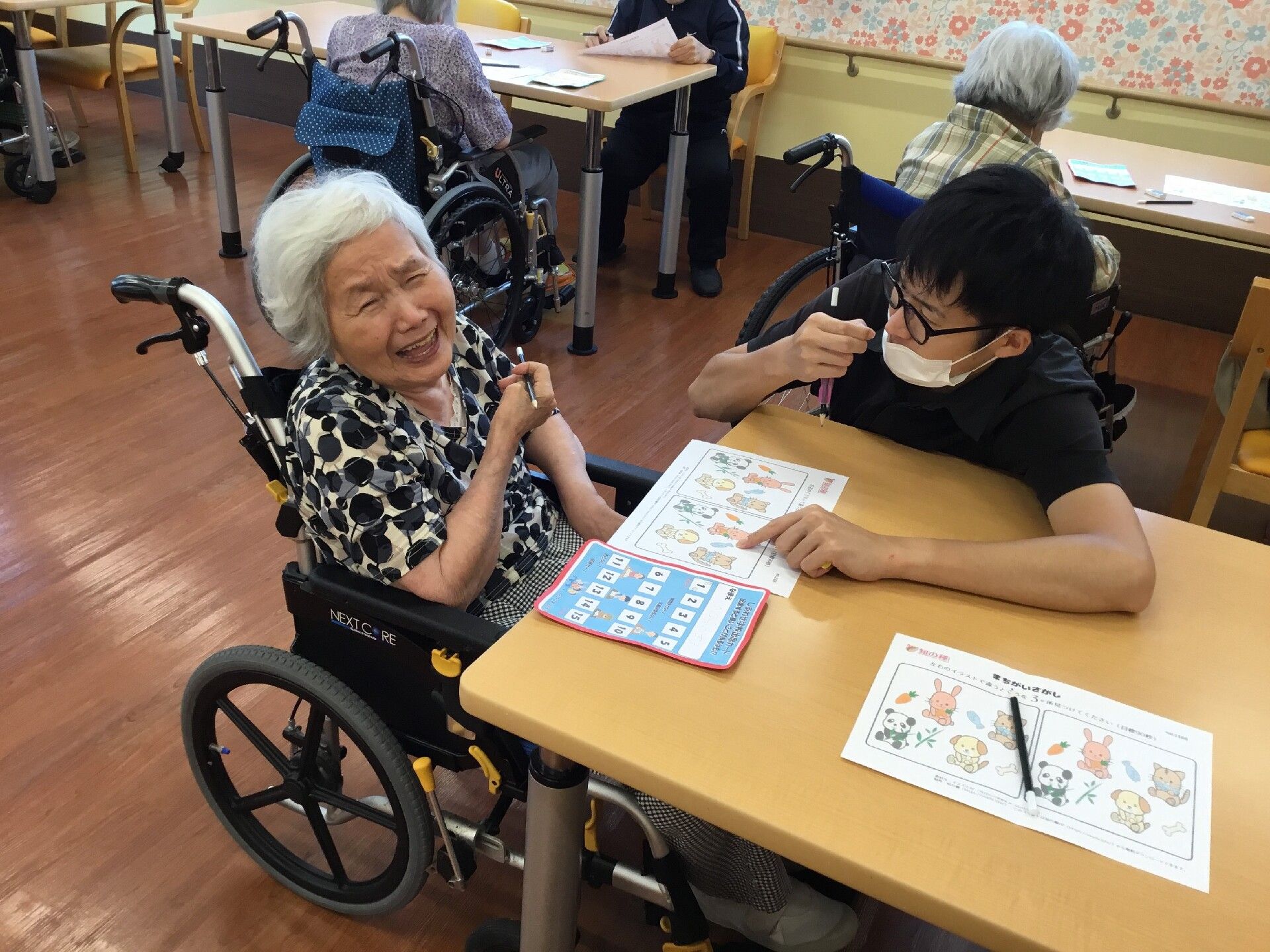 車椅子の入居者様が塗り絵をしている
