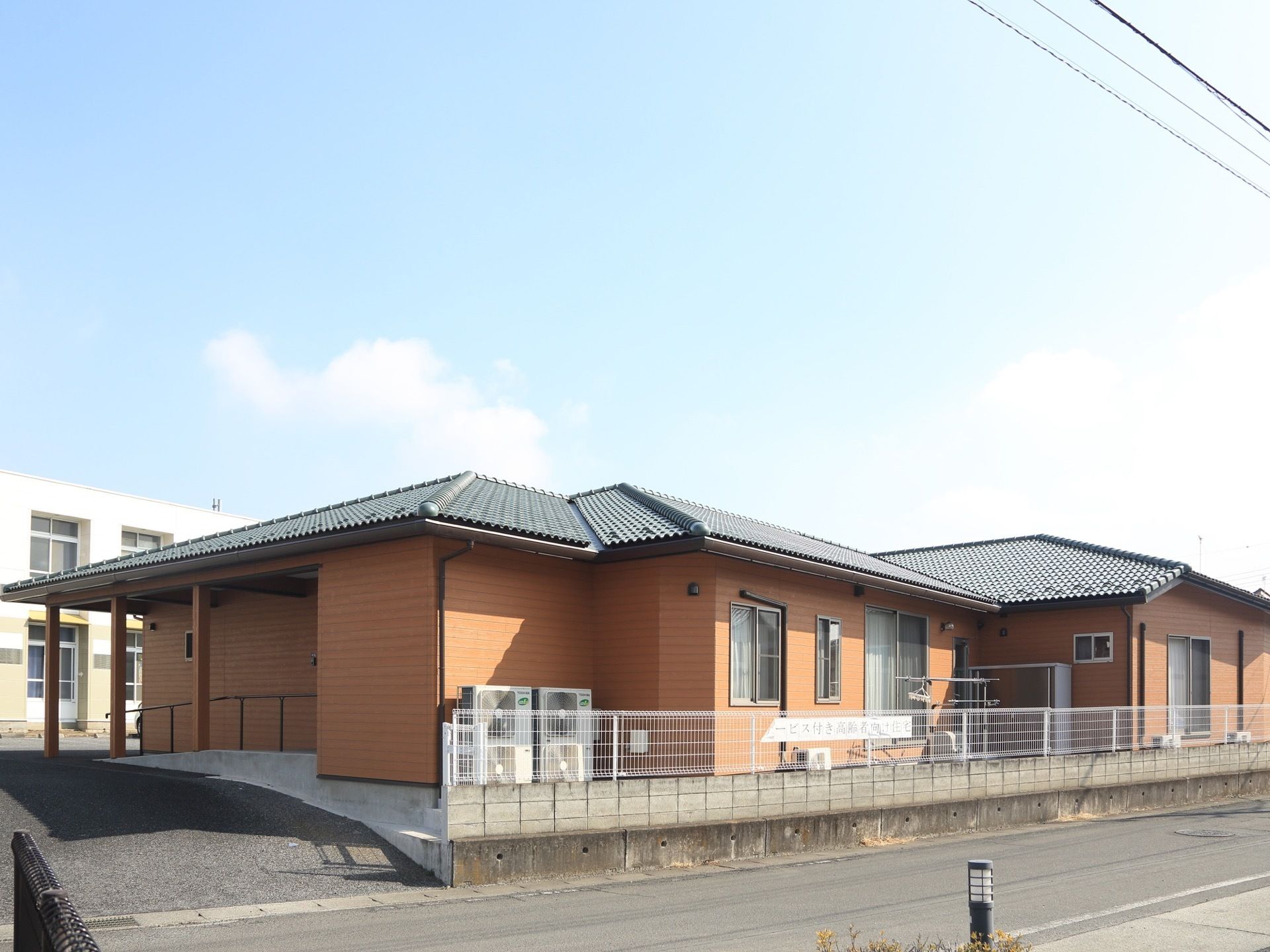 施設は、木造平屋建てである。敷地はブッロクに設置された白いフェンスで囲まれており、出入口は傾斜の緩い坂になっている。