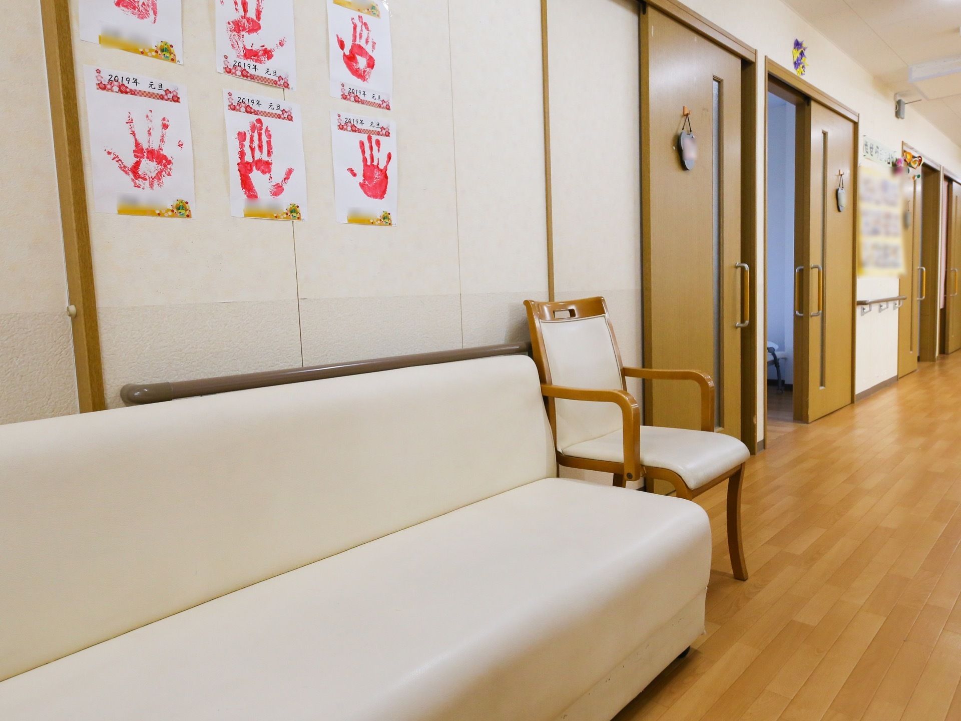 廊下の一角に、白い２人がけソファーと椅子が置いてある。そのため居室から出て、入居者様同士で交流が持てる。