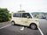 敷地内には駐車場が設置されている。車椅子用の駐車スペースも備わっている。施設名が記された福祉車両が停められている。