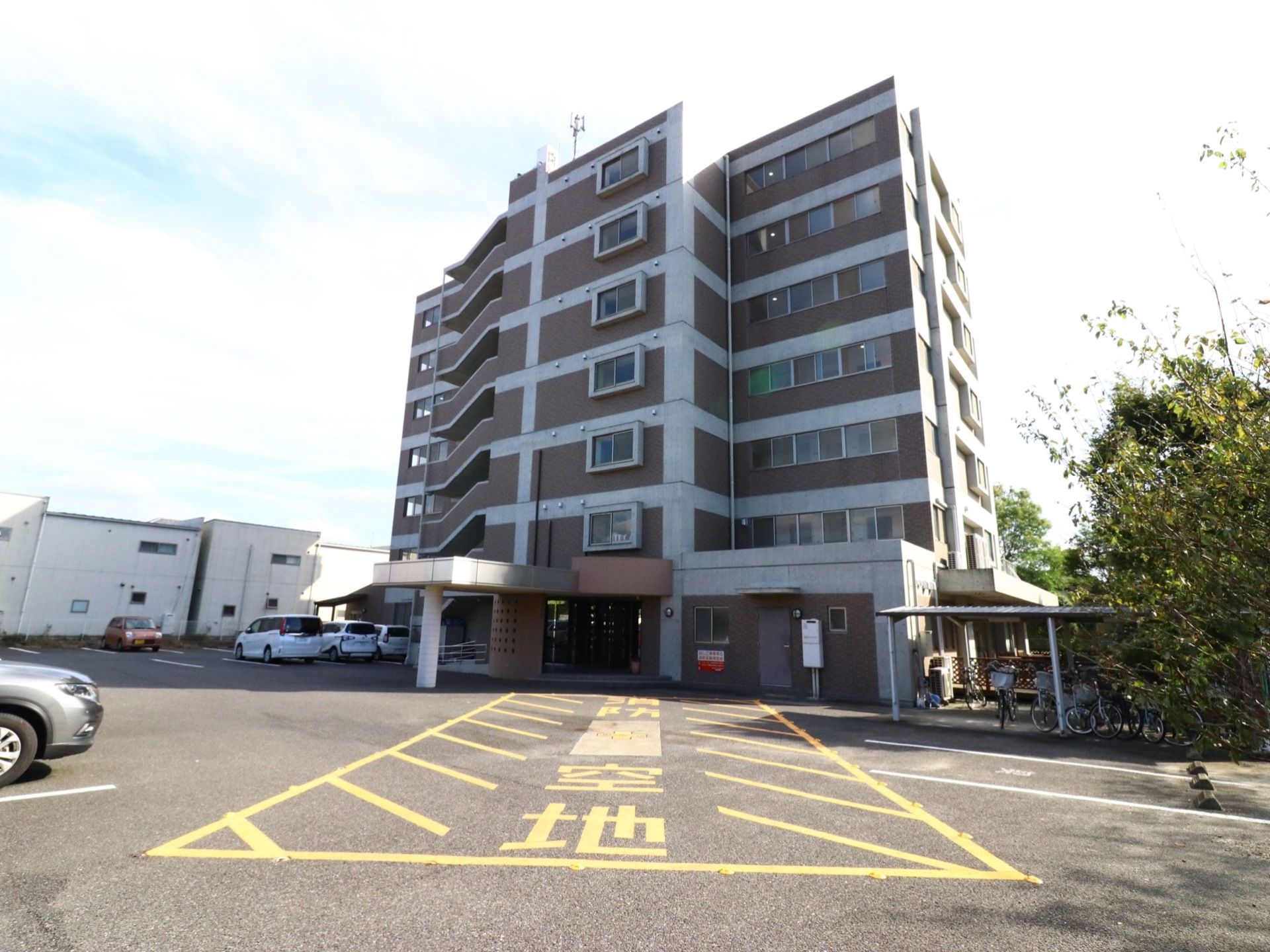 ７回建ての大きなマンションタイプの外観である。広い駐車場を備え、消防車の作業スペースが取られている。