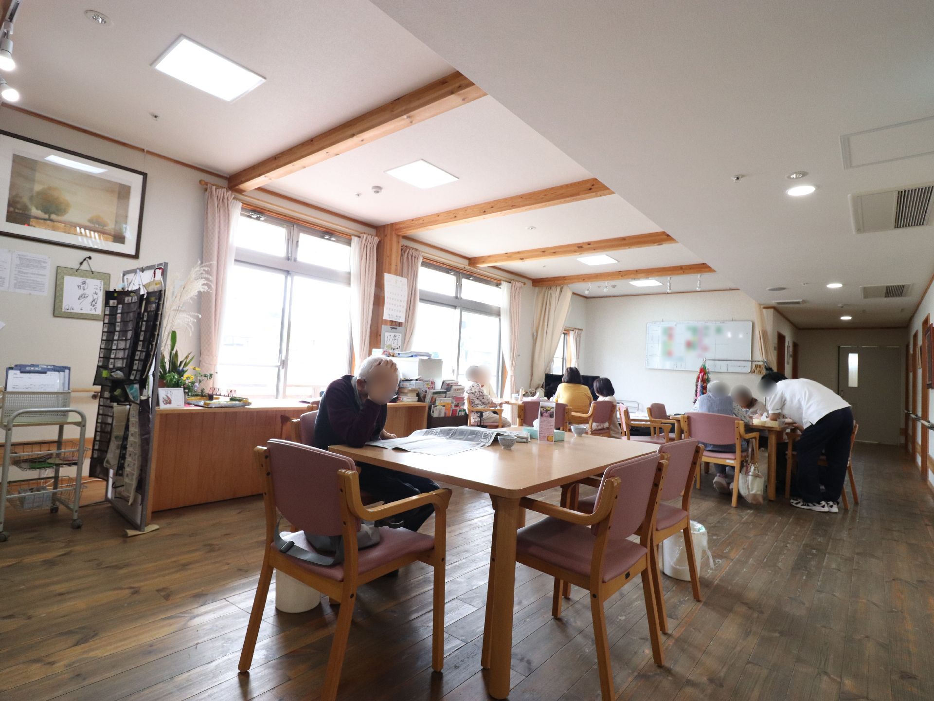 ダイニングには居住者様達が集まり、それぞれの時間を過ごしている。雑談をしている方や、新聞を読んでいる方がいる。