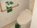 温水洗浄機能付きトイレが置かれ、壁面に手すりと緊急コールが設置されているトイレ