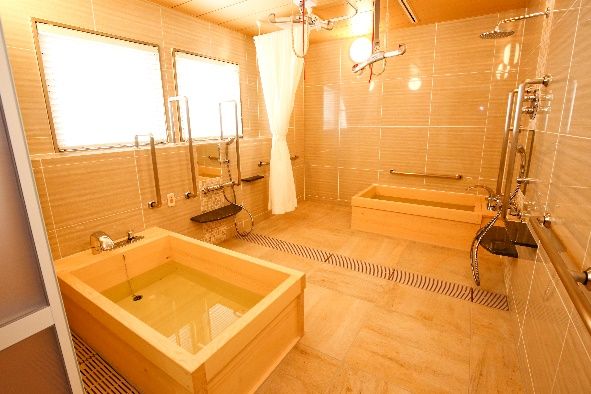 長方形のテーブルに、ベロア素材の背もたれの椅子が備えられている。壁には緑豊かな庭を描いた絵画が掛けられている。