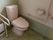 トイレには入居者様の安全のため、手すりが各所に取りつけられている。冬場の寒い時期用にヒーターも完備している。