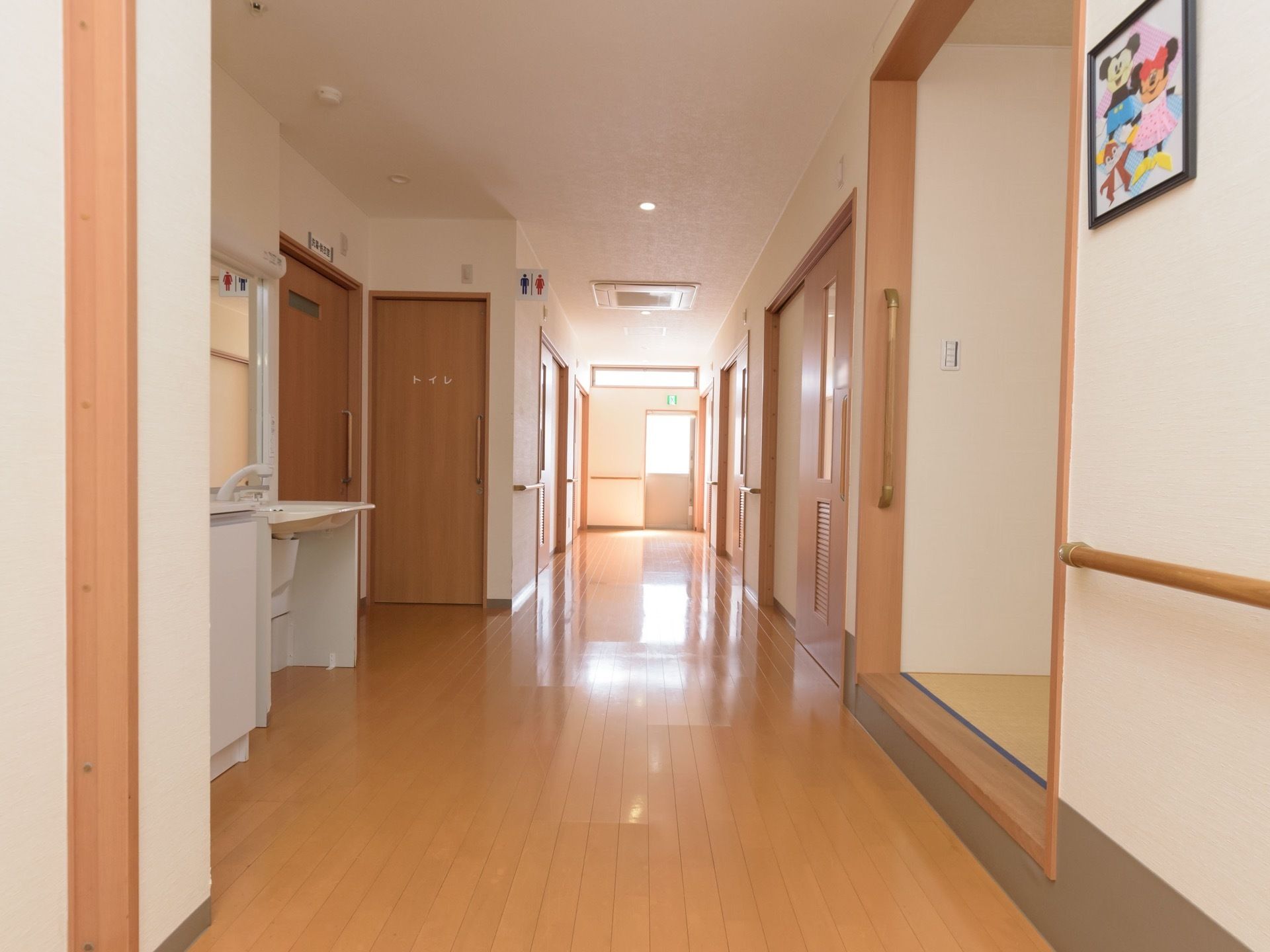 廊下に面して洗面台があり、近くには男女兼用のトイレがある。居室から近く、必要時にすぐに足を運ぶことができる。
